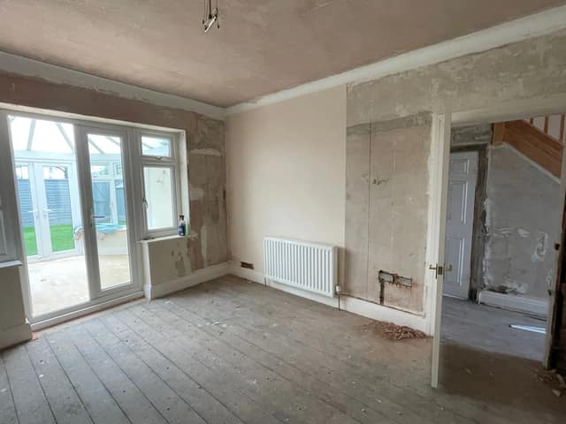Through room stripped back to plaster with sanded floorboards, ready for skim and decoration