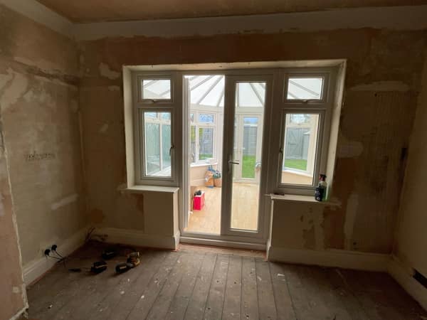 Room mid-conversion with new French doors through to the garden